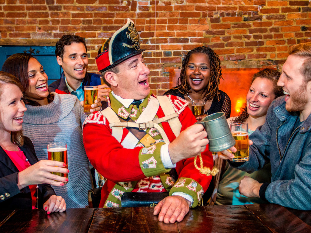 A colonial figure giving a toast during Tippler's Tour in Philadelphia's Historic District.