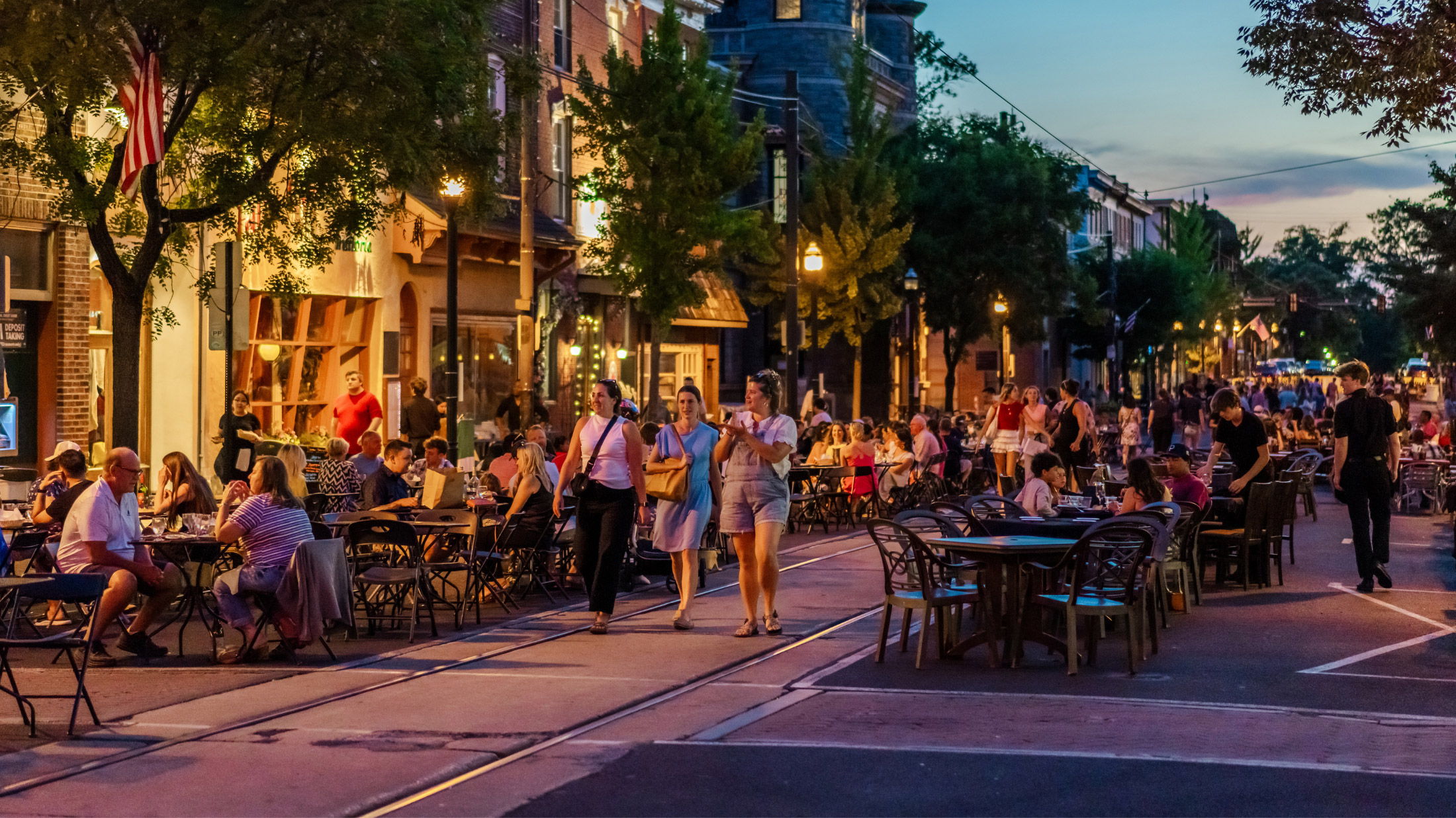 People dine and walk on the streets of Media in Delaware County