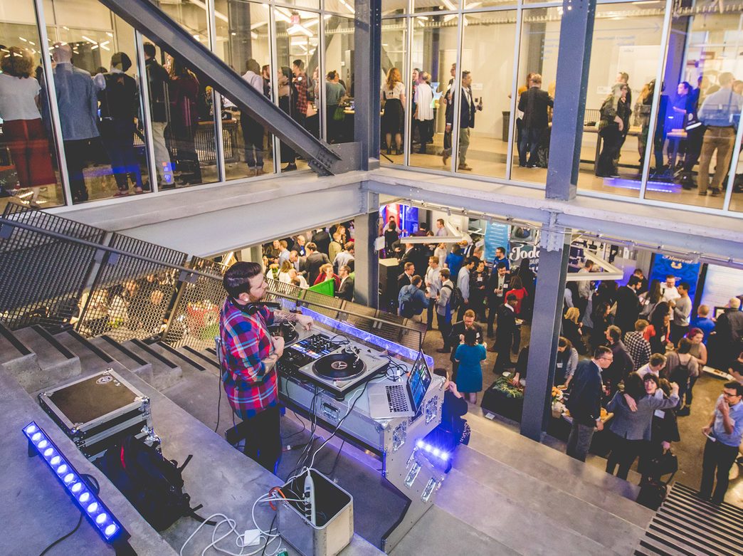 A DJ spins at the top of a staircase during a Philly Tech Week event