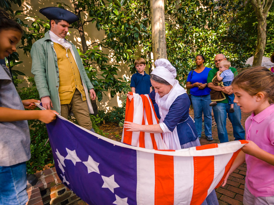 Betsy Ross reenactor folds an American flag at the Betsy Ross House in Philadelphia