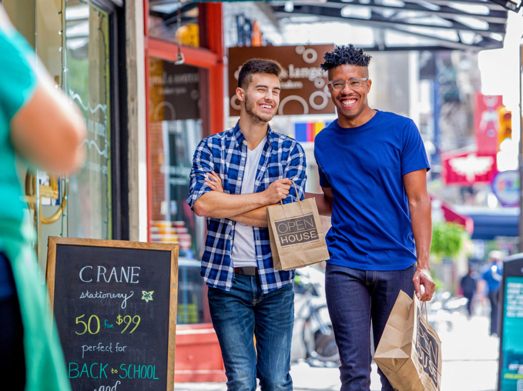 People carry shopping bags on 13th Street in Philadelphia's Gayborhood