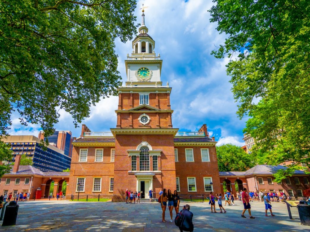 People posing for a photo in front of Independence Hall in Philadelphia