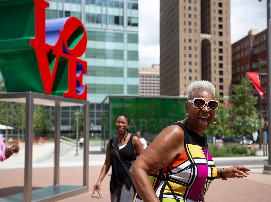 Women posing in front of the LOVE sculpture in LOVE park