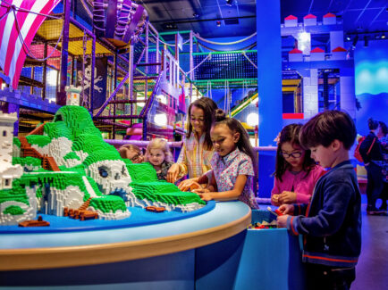 Children build with LEGOs at LEGOLAND Discovery Center
