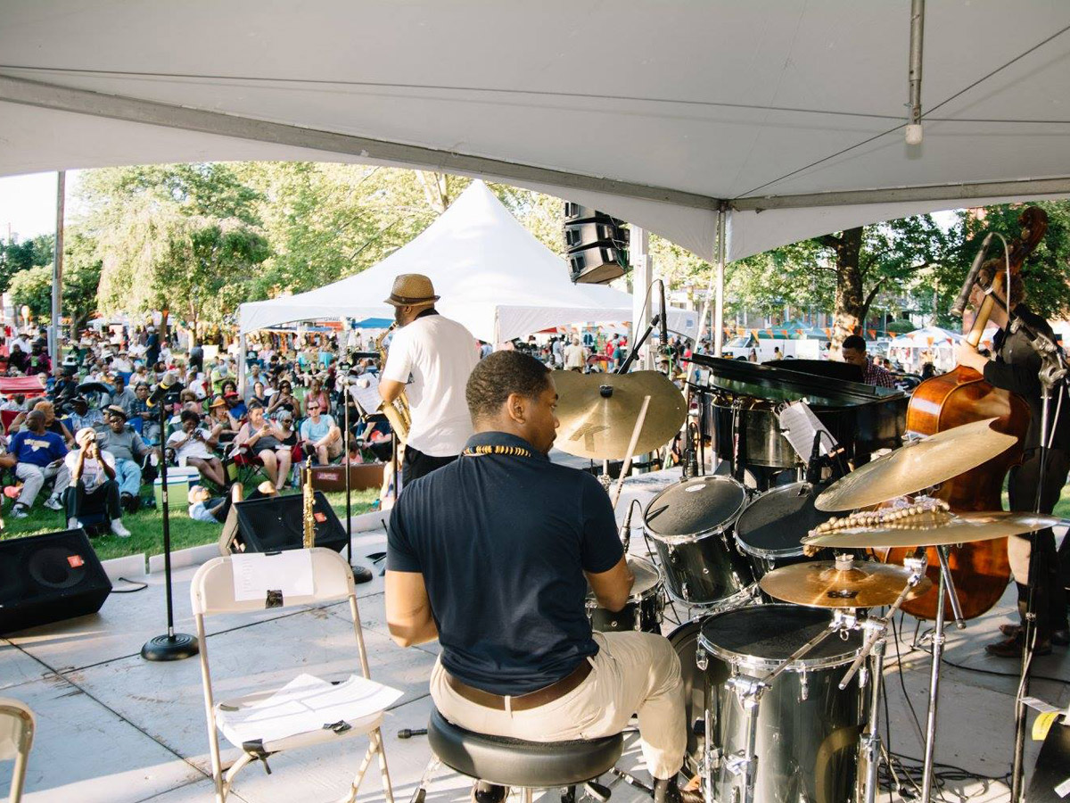 A band plays to an outdoor crowd on a lawn during the Lancaster Avenue Jazz Festival in West Philly.