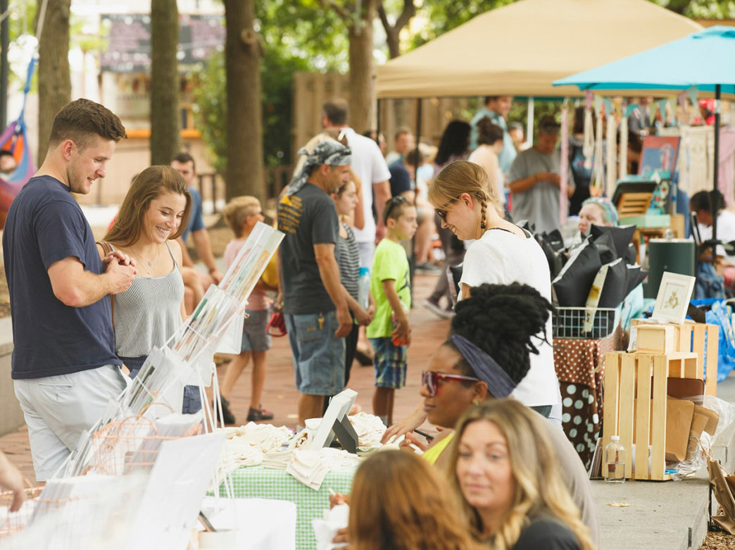 Shoppers looking at items by makers at the Art Star Pop Up Market in Spruce Street Harbor Park