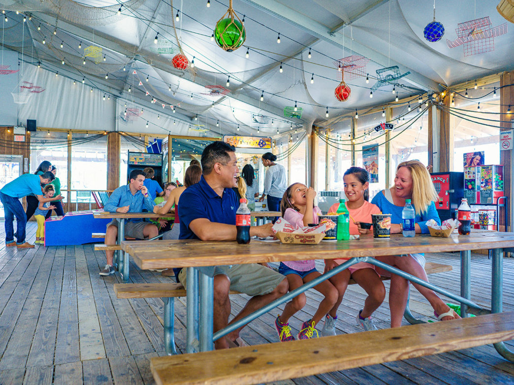 Family eating Chickie's & Pete's at Blue Cross RiverRink Summerfest