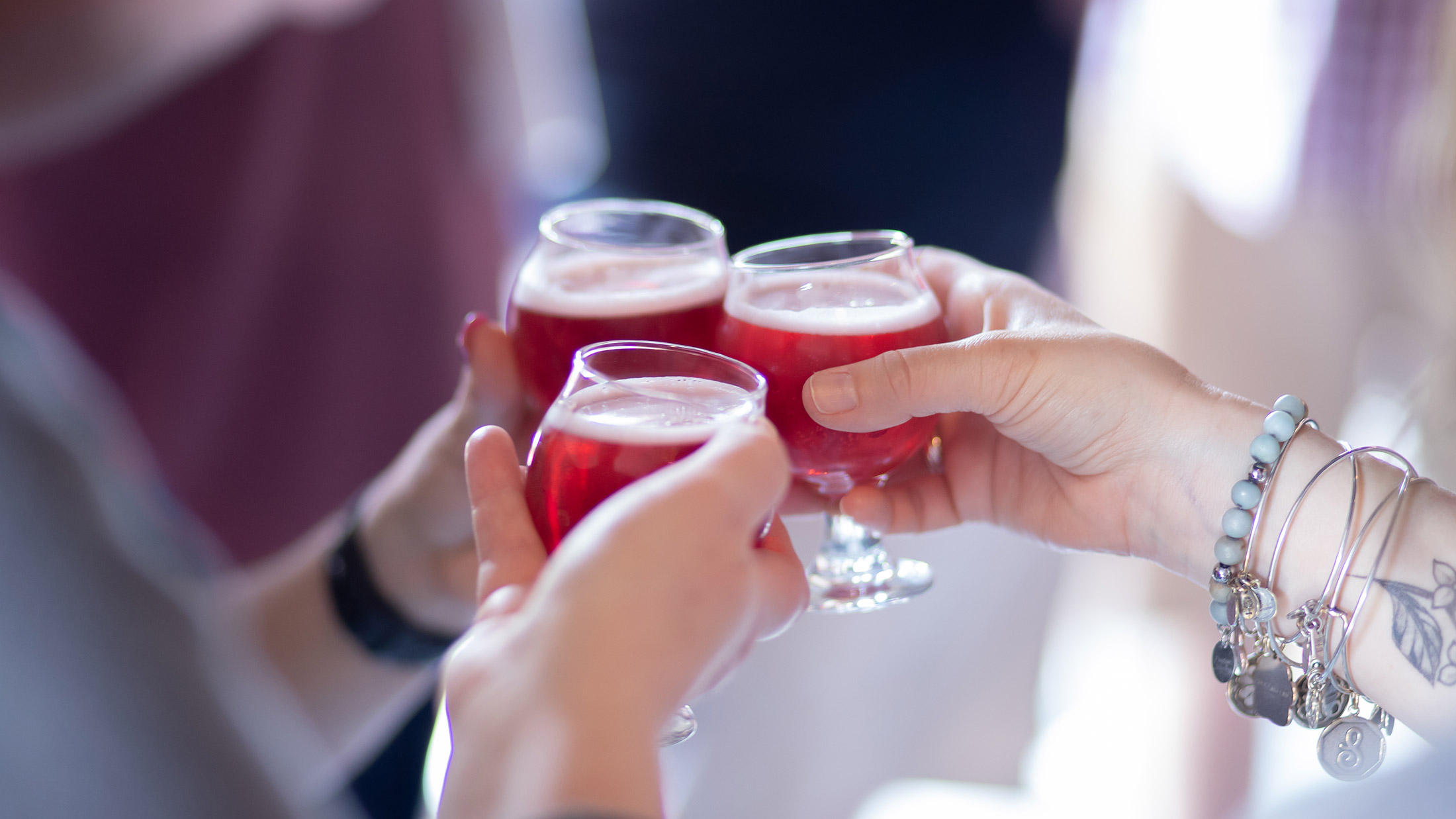 Three people cheers a sample of beer on City Brew Tours Philadelphia