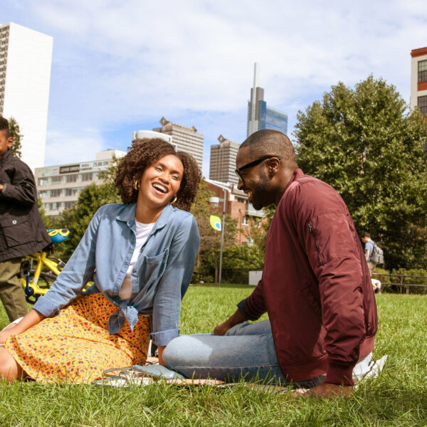 A family laughing and playing at Schuylkill Banks in Philadelphia