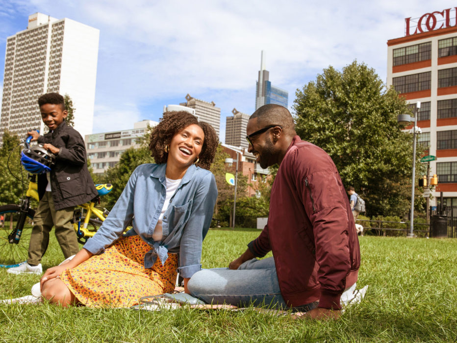 A family laughing and playing at Schuylkill Banks in Philadelphia