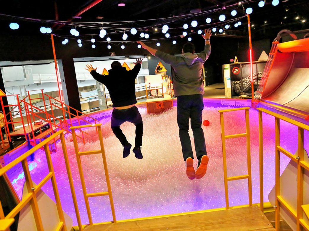 People jumping into the ball pit at The Franklin Institute