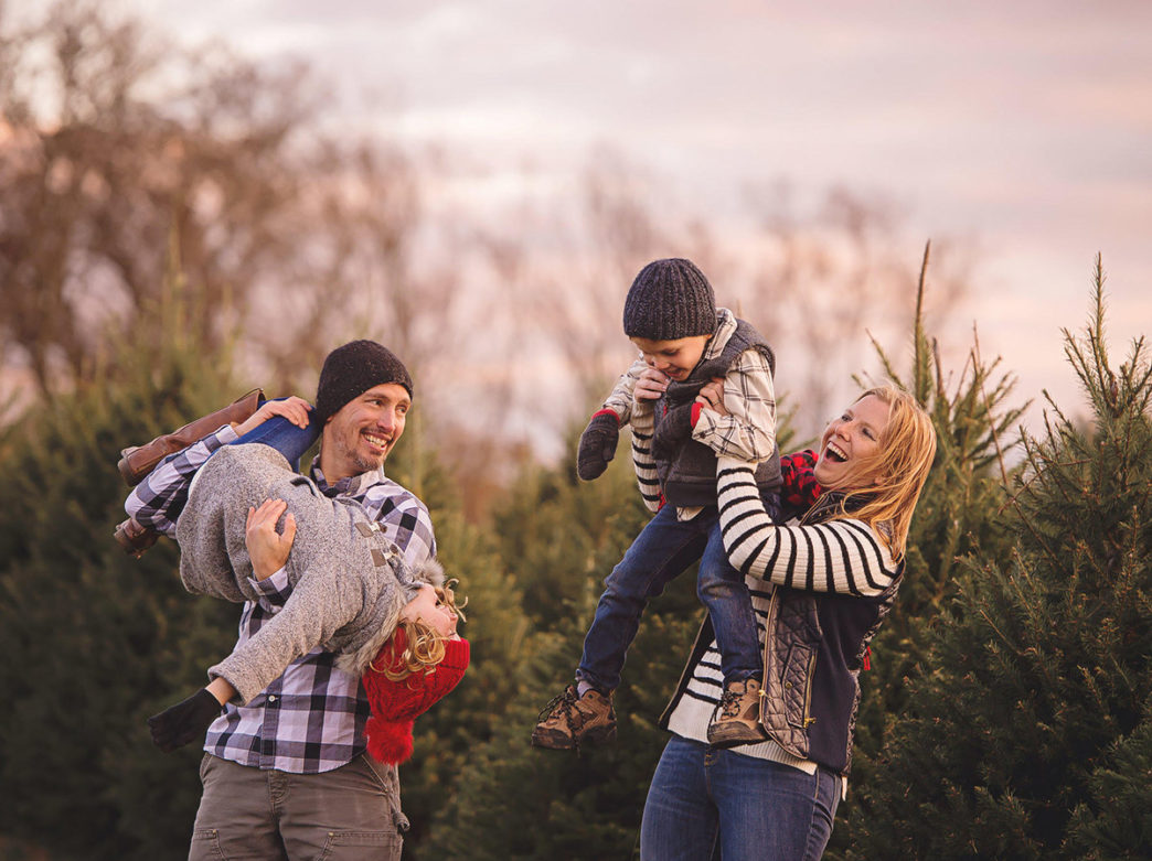 Family in the field of Christmas trees at Linvilla Orchards