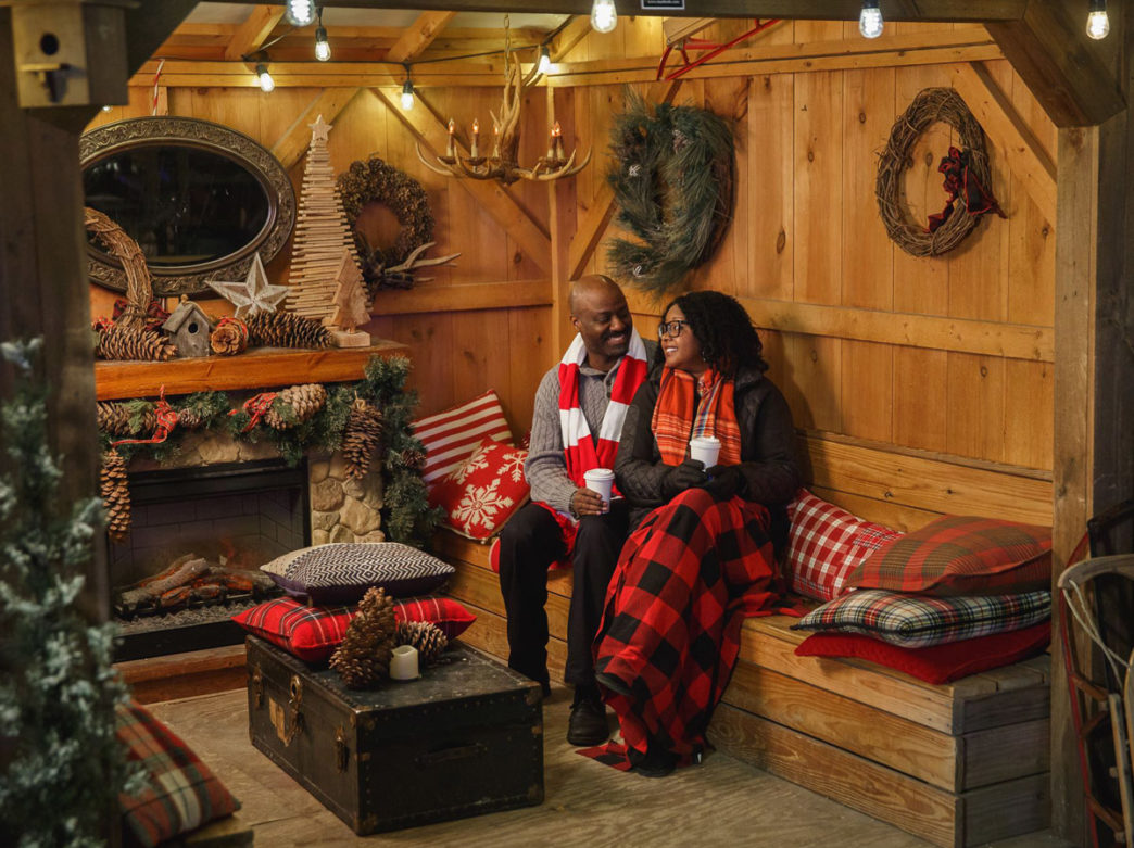 A couple enjoying the cabins at Blue Cross RiverRink Winterfest