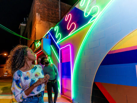 People at the Electric Street neon mural in Philadelphia