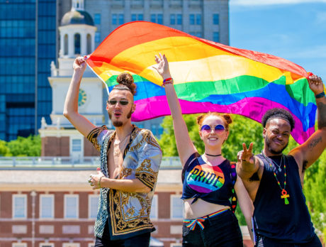 People with a Pride flag outside Independence Hall in Philadelphia