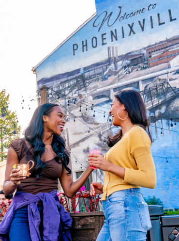 Two women enjoying an outdoor restaurant in Phoenixville.