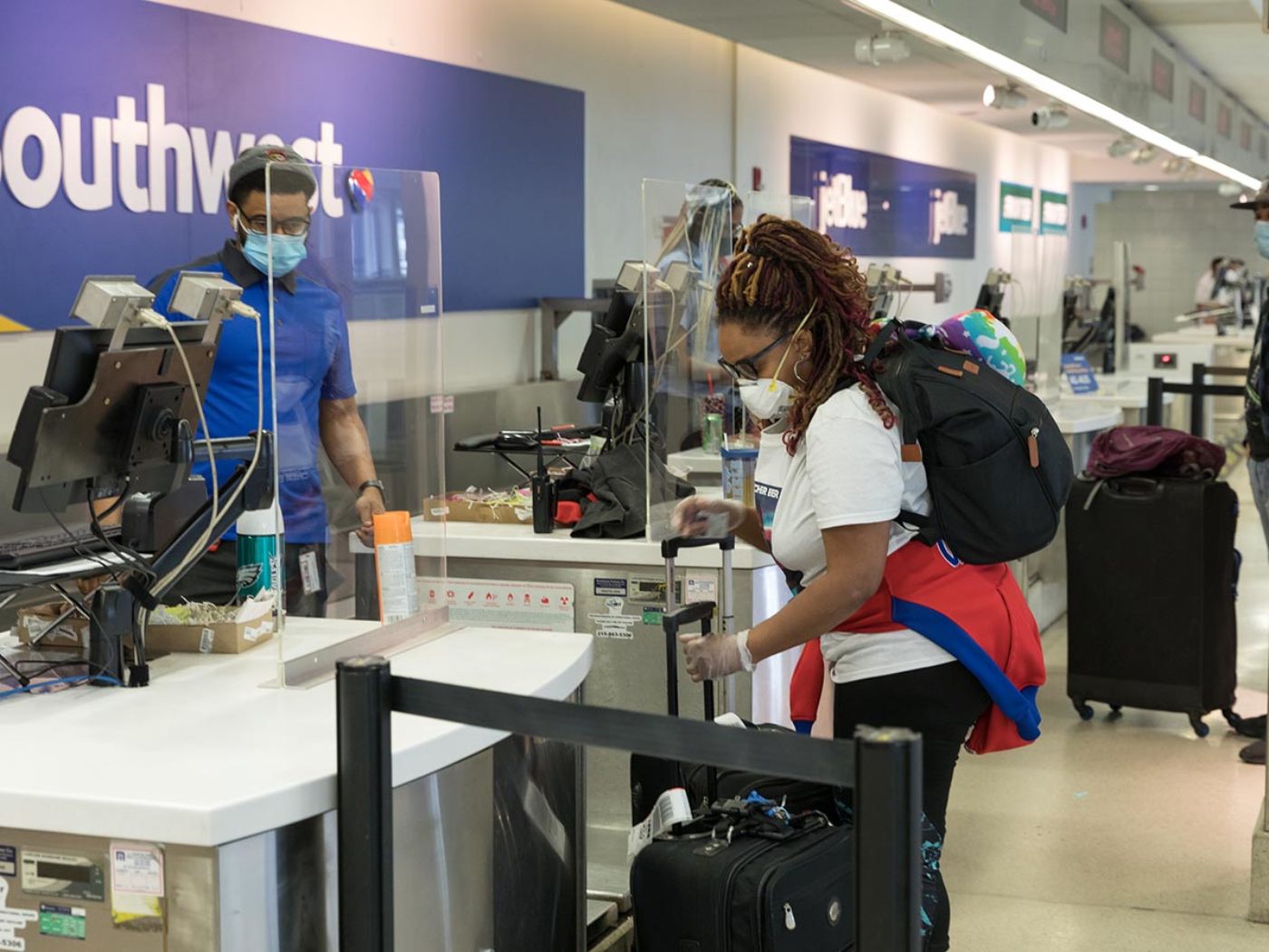Woman goes through security at Philadelphia International Airport.