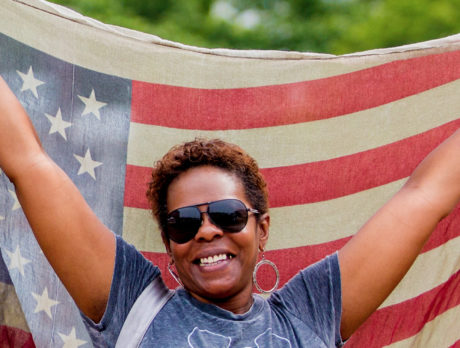 A person holds a flag on Independence Mall in Philadelphia