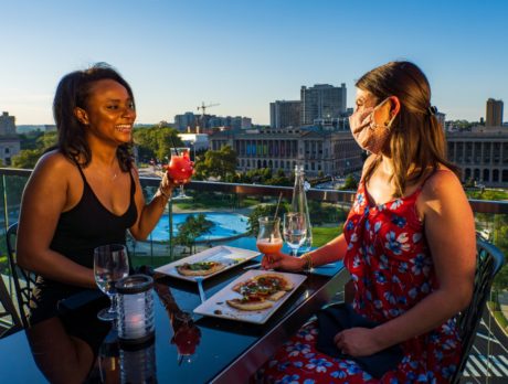 Two people drink and dine at the Rooftop Assembly Lounge in Philadelphia
