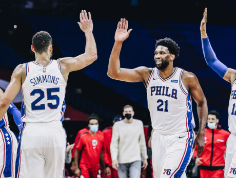 Joel Embiid of the Philadelphia 76ers high fives his teammates