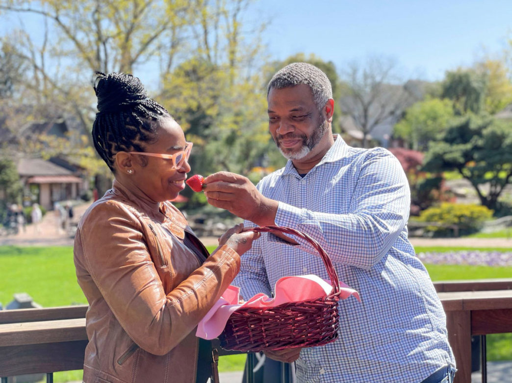 A man feeds a woman strawberries at Peddler's Village