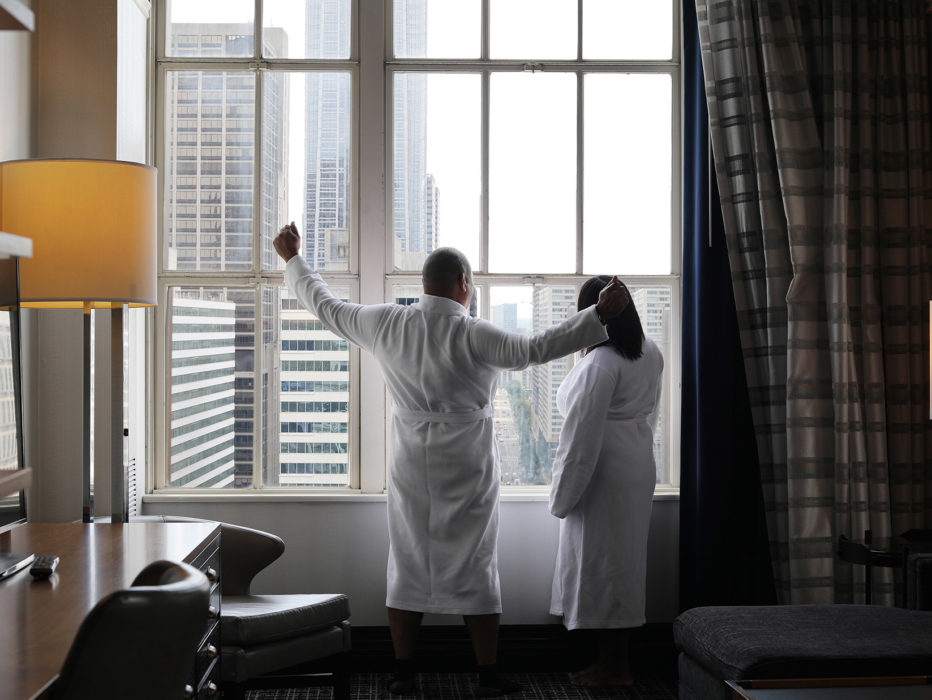 A person stretches in front of a window at a hotel in Philadelphia