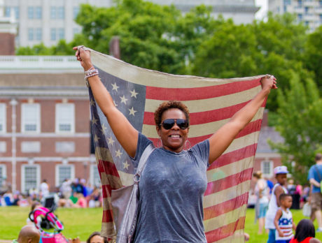 A person holds an American flag on Independence Mall in Philadelphia