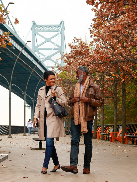 A couple strolls on Race Street Pier in Philadelphia
