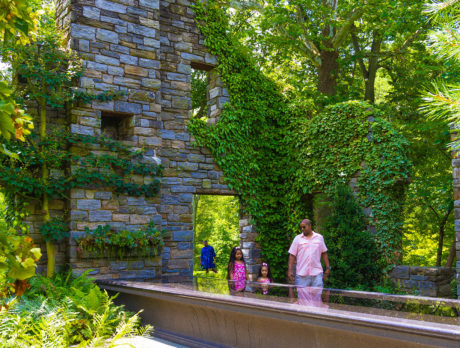 A family walks through the ruins at Chanticleer