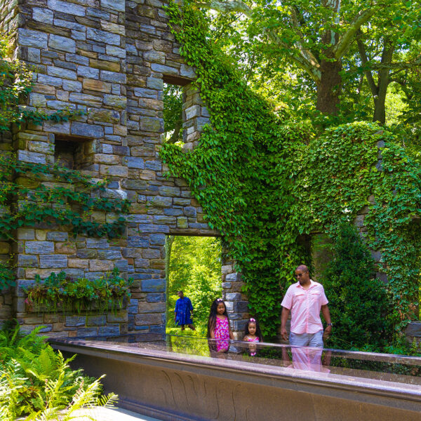 A family walks through the ruins at Chanticleer