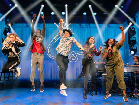 Performers in Freestyle Love Supreme jump in the air during a performance