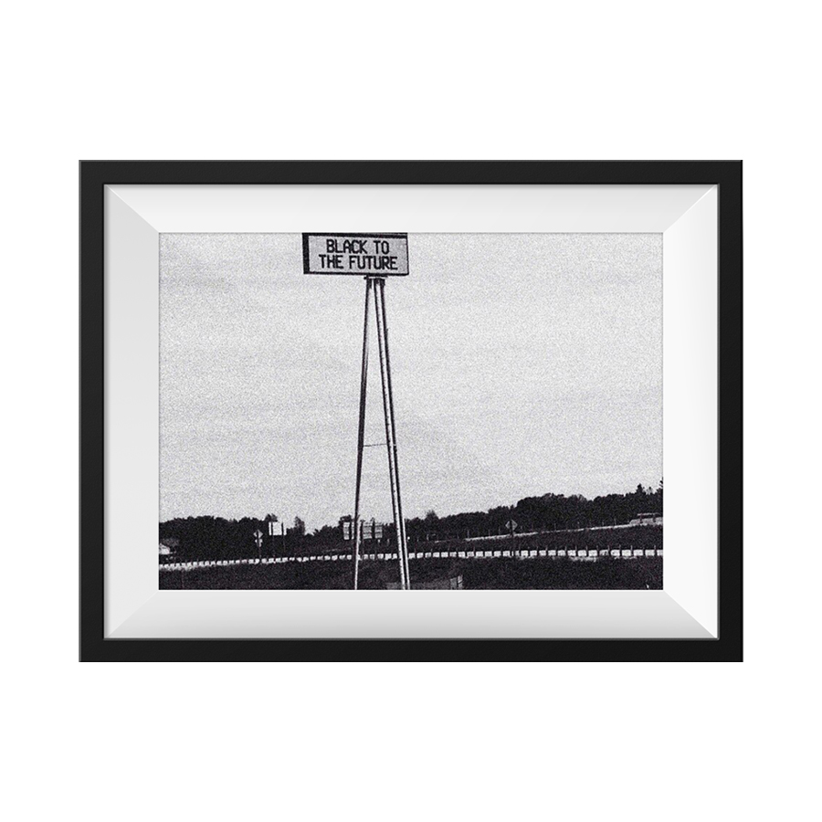 A picture of a sign that reads Black to the Future and is elevated on stilts