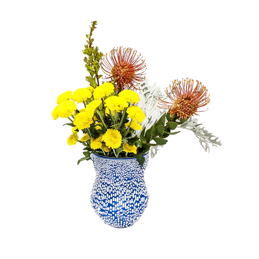 A blue vase with colorful flowers inside of it