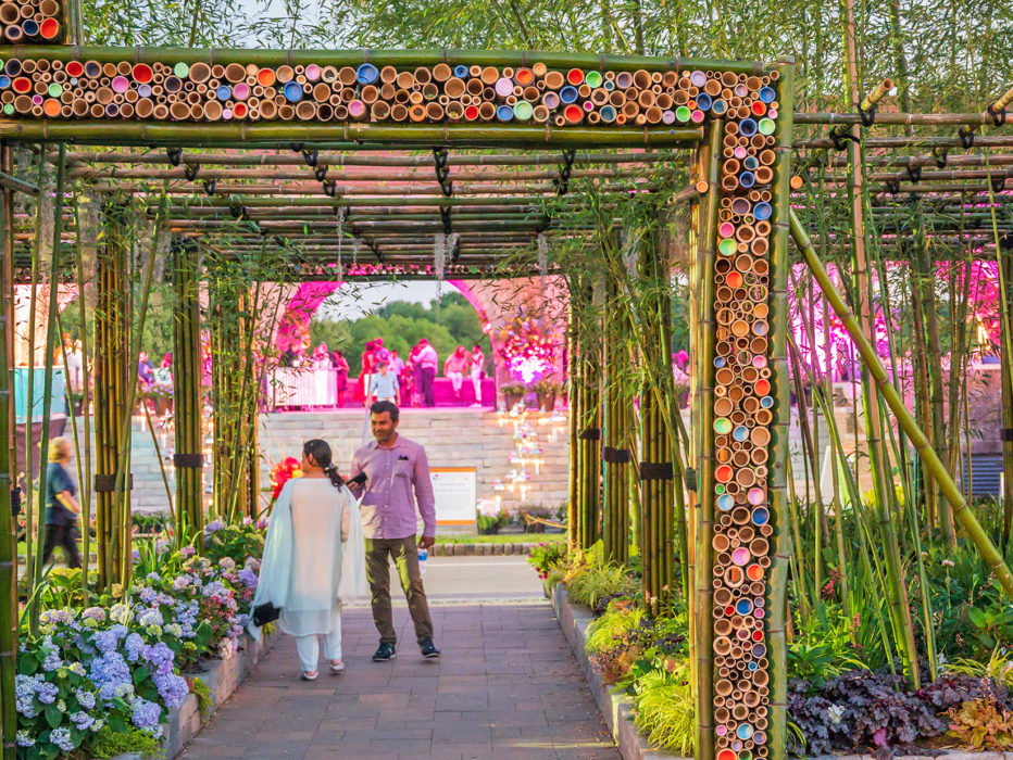 Two people walk through a display at the Philadelphia Flower Show