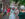 Two women dressed in colonial garb pose for a photo during Fete Day at Elfreth's Alley