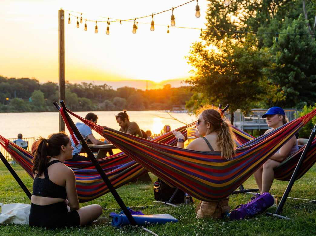 People sit in hammocks at sunset during Parks on Tap at Fairmount Water Works