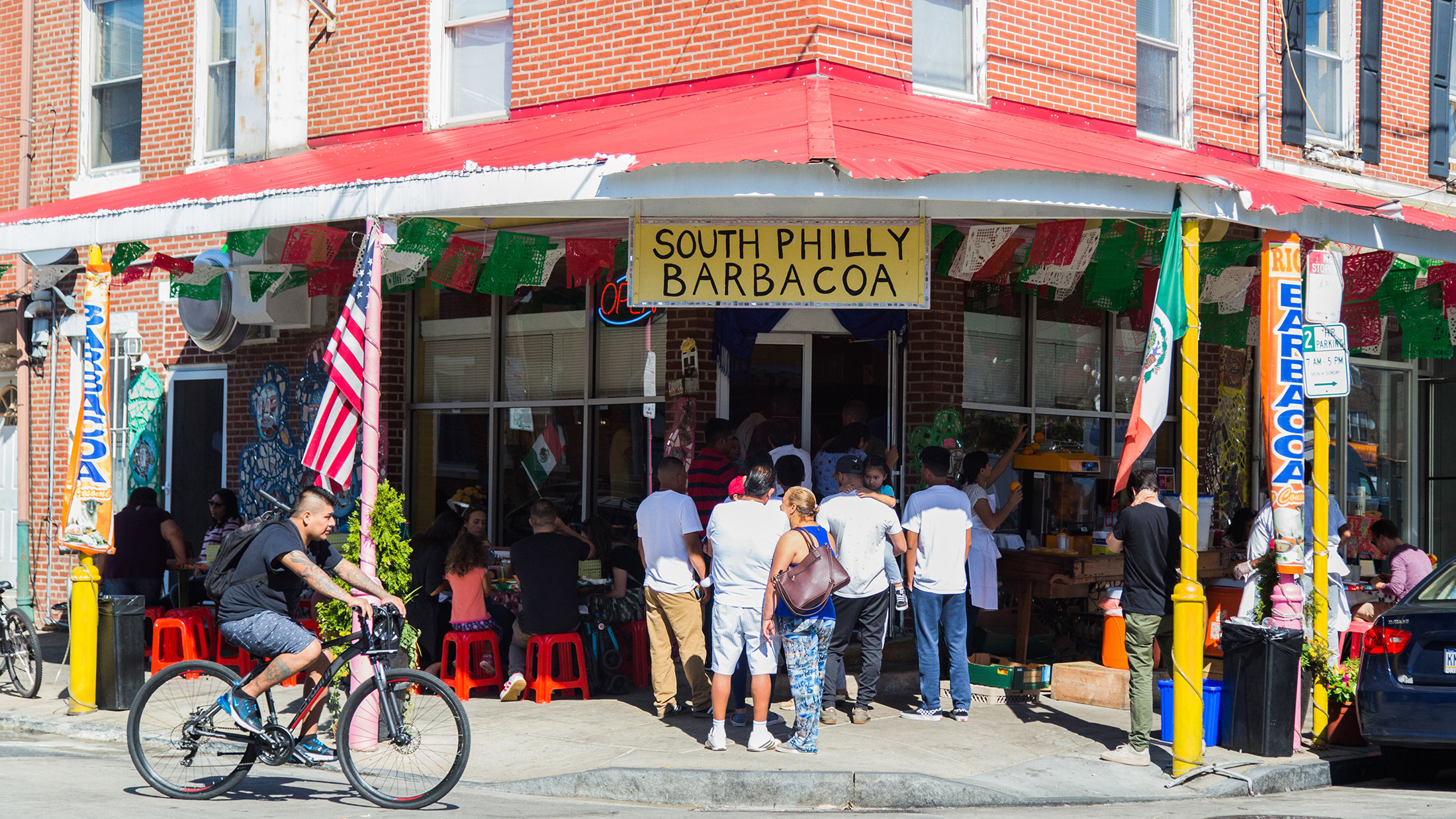 A crowd gathers at the exterior of South Philly Barbacoa in the Italian Market