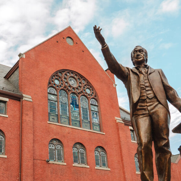 The red exterior of Mother Bethel Church in Philadelphia, with a statue of Richard Allen raising his hand in front of the church