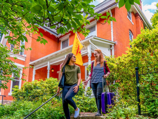 A couple walks down the stairs outside Akwaaba Bed & Breakfast in Philadelphia