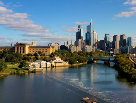 The Philadelphia Museum of Art sits on a hill elevated above the Schuylkill River, with the Philadelphia skyline in the background