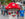 A child wearing a blue shirt stands next to a mushroom mascot during the Kennett Square Mushroom Festival