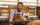 A waiter holds a tray of drinks and smiles at the camera