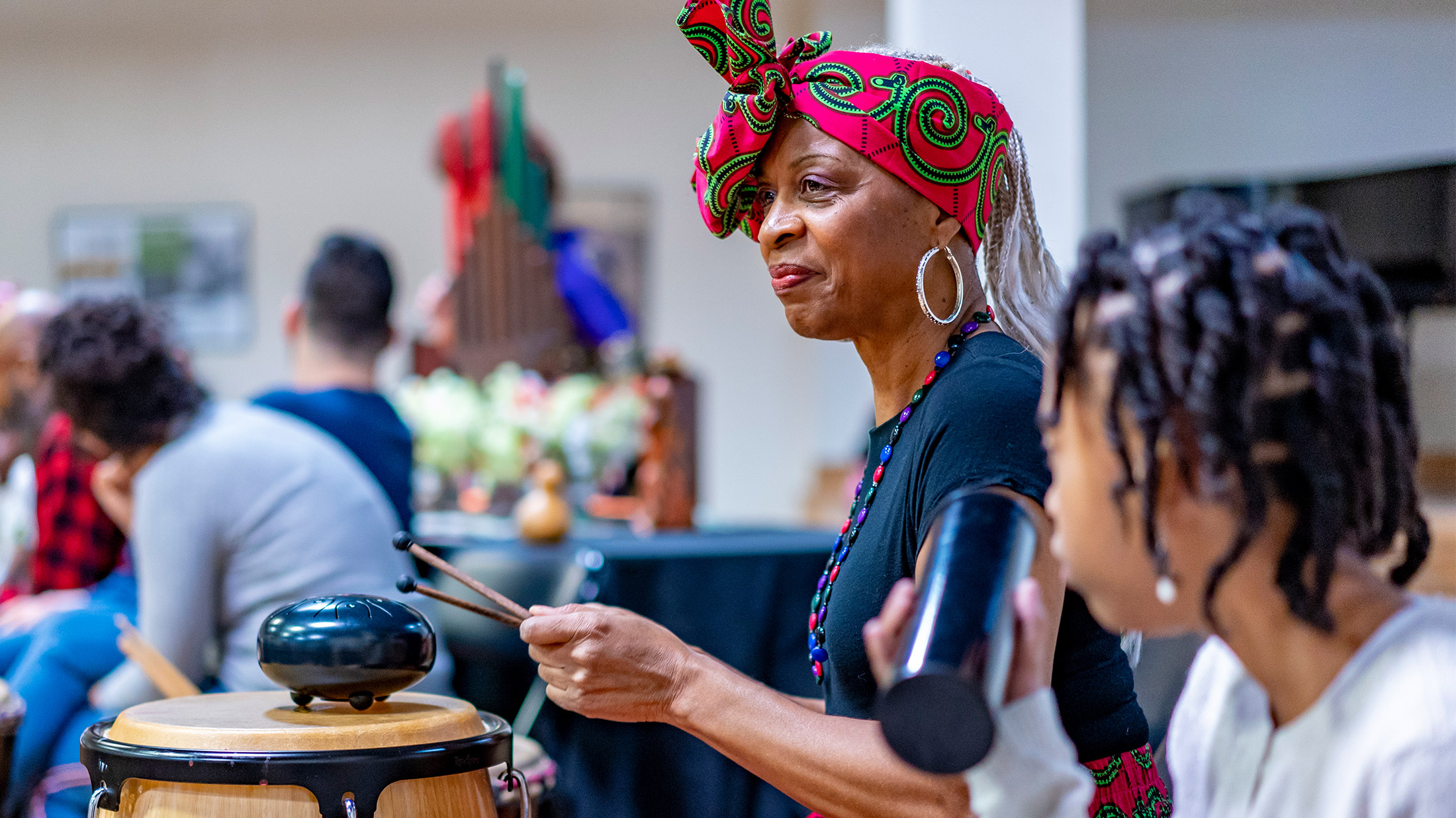 A woman plays drums during a Kwanzaa celebration at The African American Museum in Philadelphia