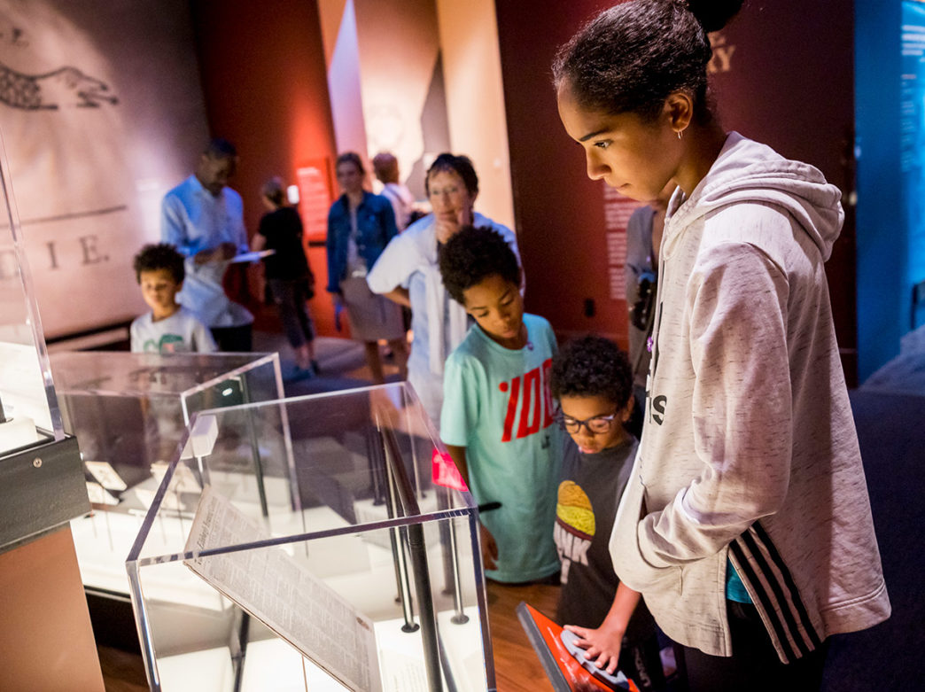 Visitors browse through glass displays at the Museum of the American Revolution