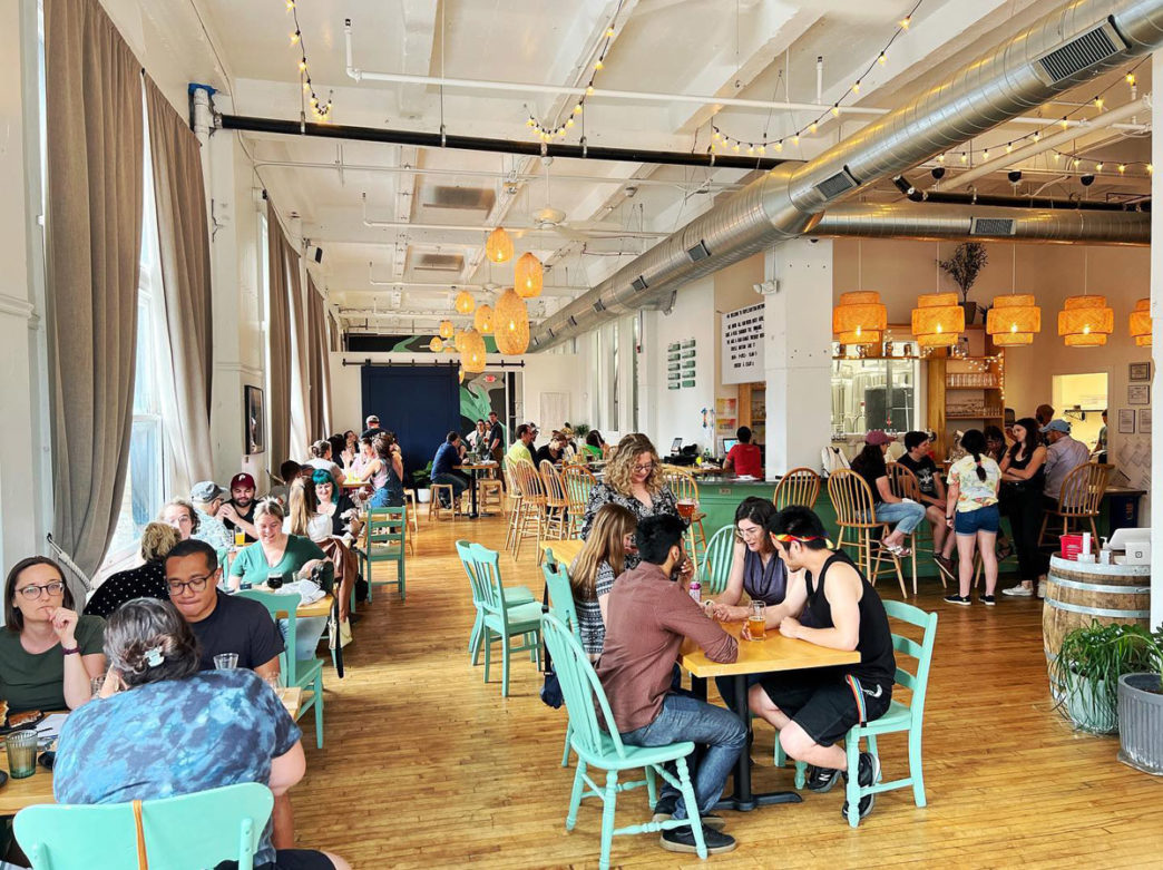 Inside Triple Bottom Brewing Company with people sitting at tables