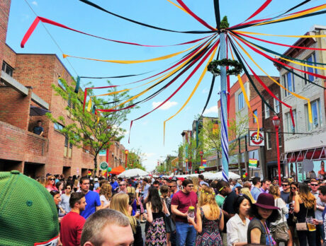 A crowd of people around a Maypole at South Street Fest