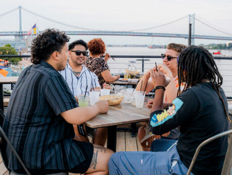 A group of four men sits at a table at Liberty Point