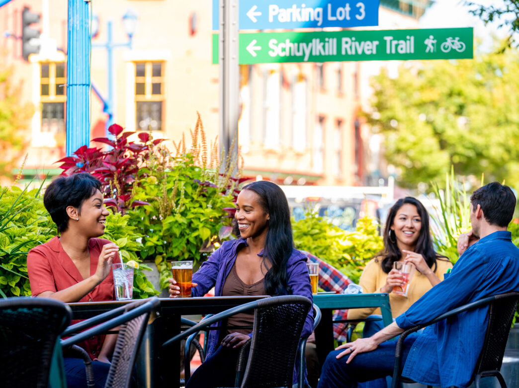 Group enjoying drinks at a brewery by the Schuylkill River Trail