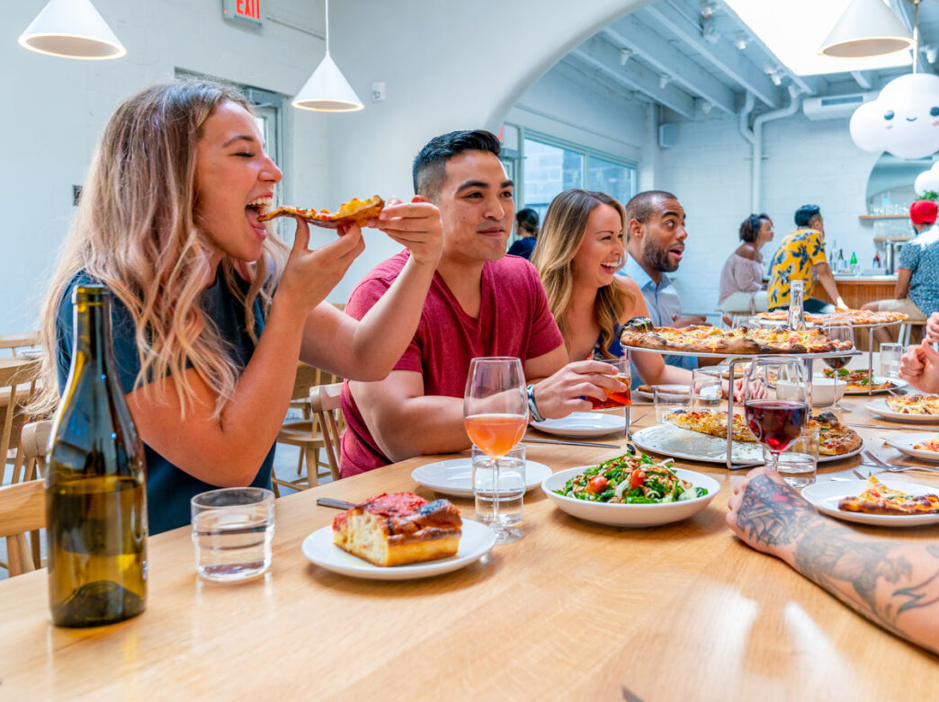 People eating pizza at Pizzeria Beddia