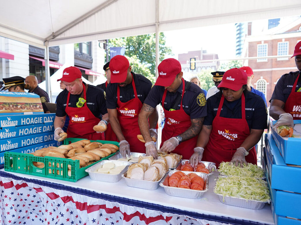 Members of the Philadelphia Fire Department assemble hoagies during the Wawa Hoagie Day competition.